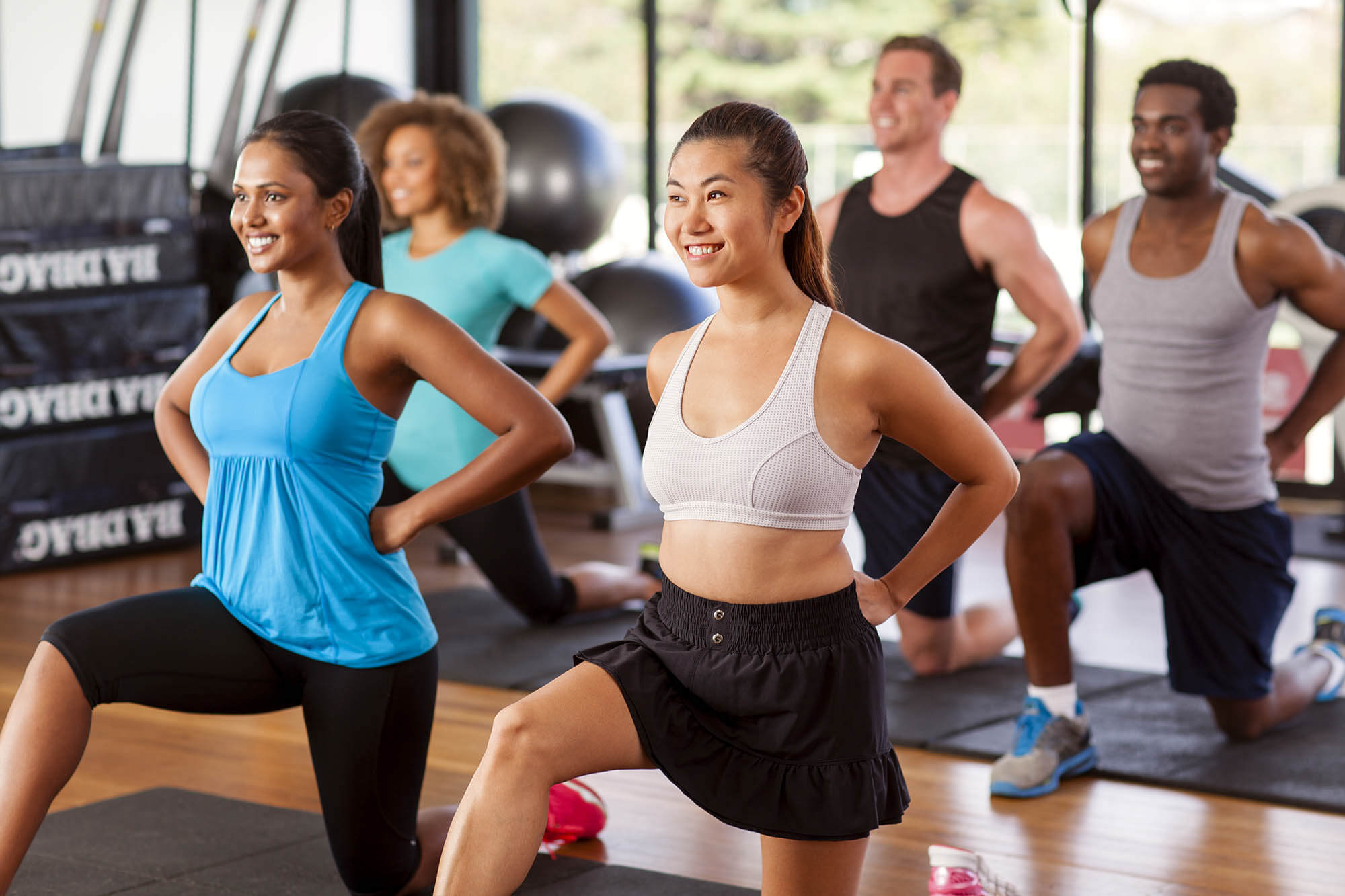 Multi-ethnic,Group,Stretching,In,A,Gym,Before,Their,Exercise,Class